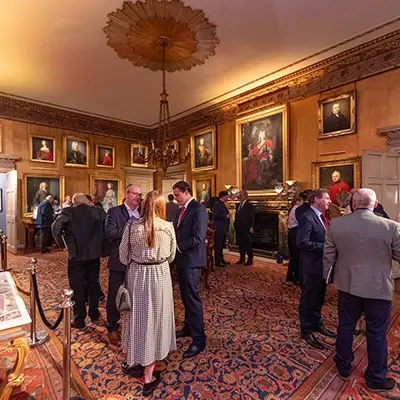 A group of people looking at auction lots in a room prior to The Distillers One of One Auction in 2023